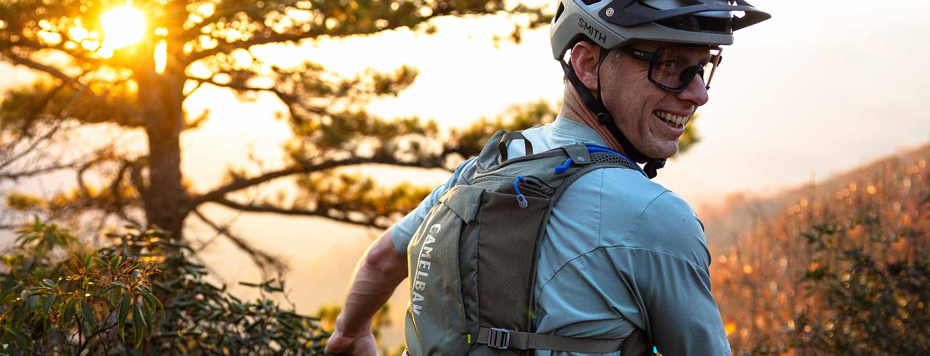 Man in riding gear outdoors with Camelbak hydration pack 