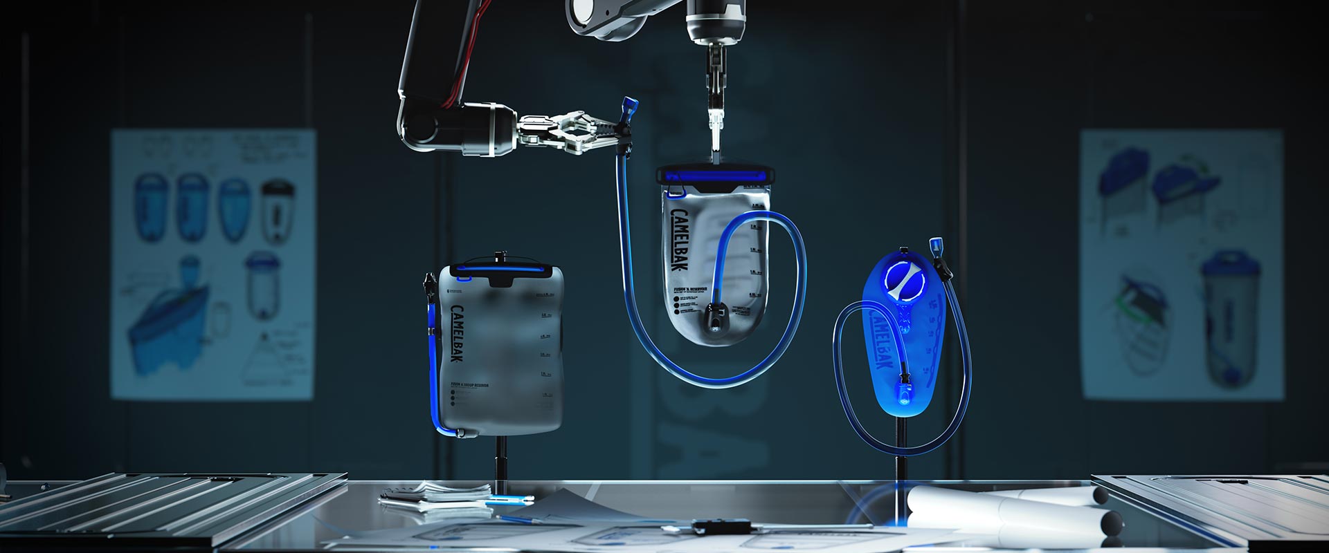 Robotic arms holding CamelBak hydration reservoirs on a workbench, with design sketches visible in the background
